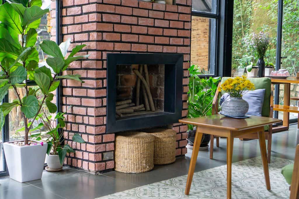 Brick fireplace surrounded with plants
