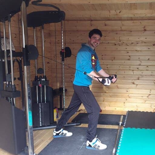 A man working out in a gym shed