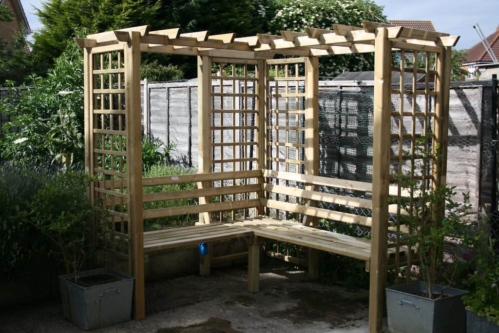 Corner arbour with trellis and seating area