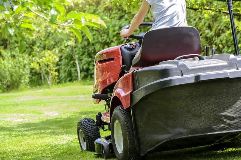 A person on a lawn mower truck