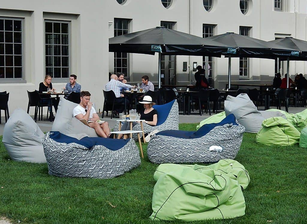 Customers sitting on beanbags at an outdoor beanbag cafe