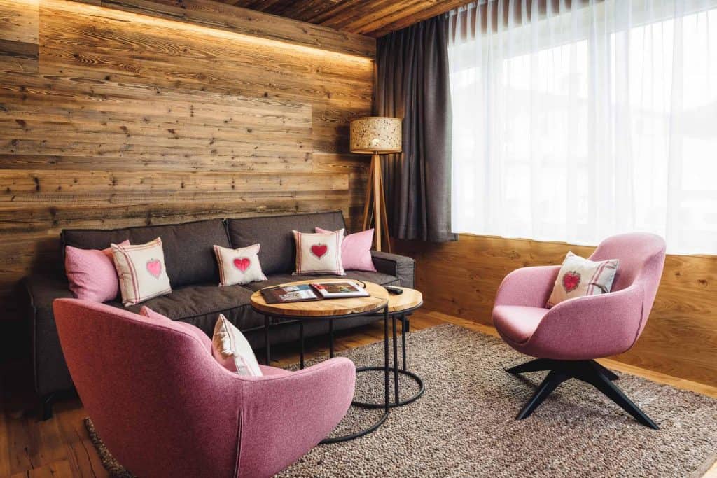 She shed log cabin with love pink furniture seating and sheer curtains