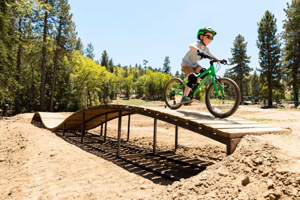 A kid riding a bike on a ramp