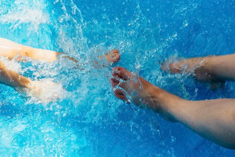 Kids feet soaked in the pool