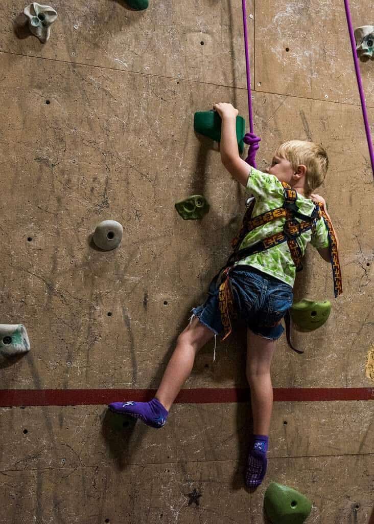 A kid on a wall climber