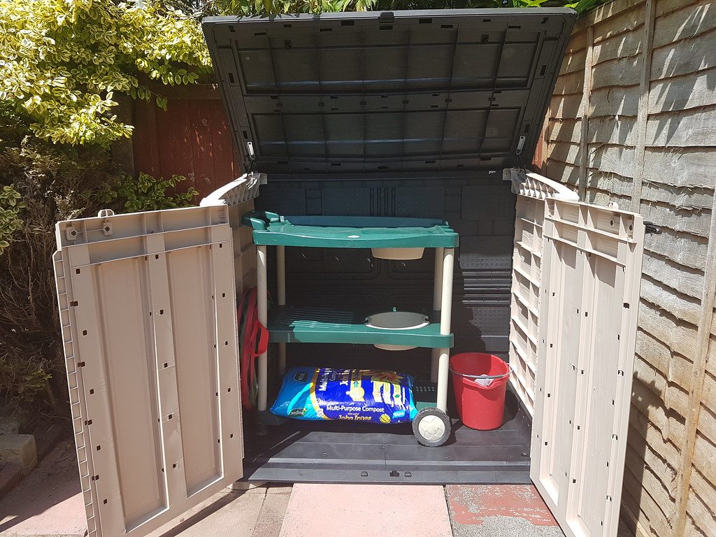 Garden storage bin that contains pet foods