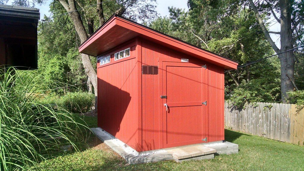 Red lean-to shed with solid foundation