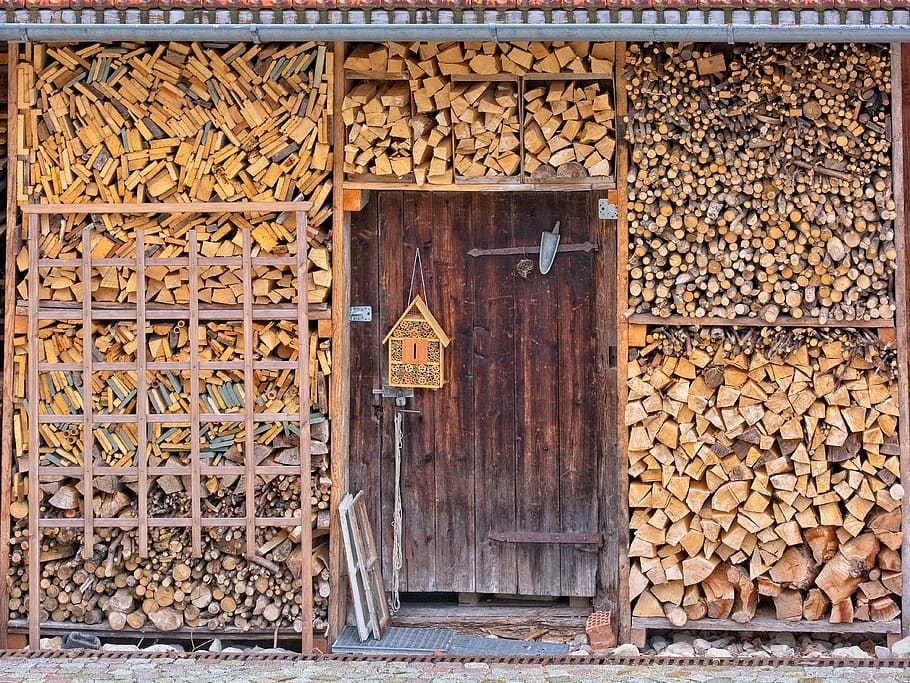 Garden log store filled with stacked logs