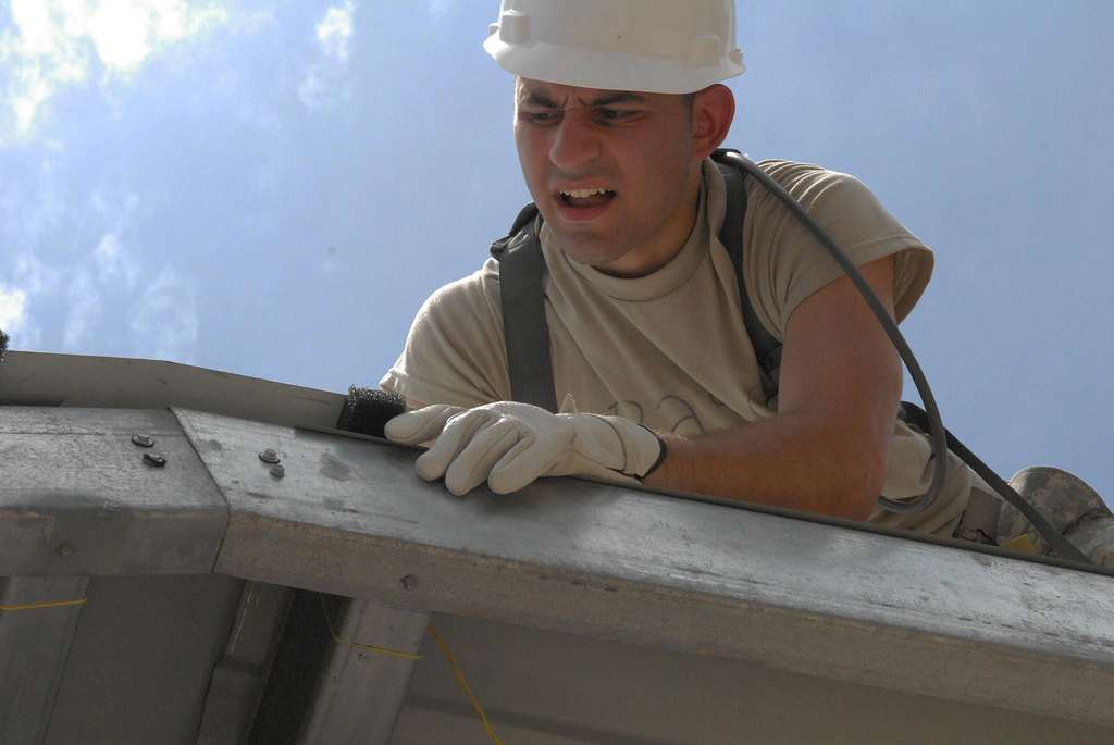 An expert placing weatherstripping on the roof