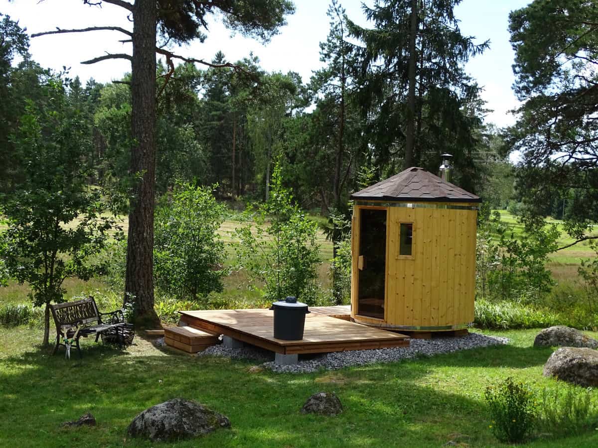 Mini outdoor sauna with a small deck