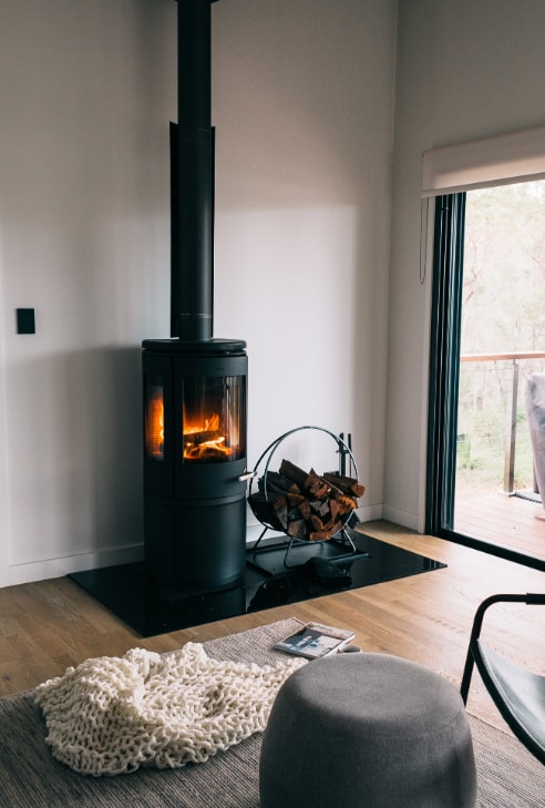 Cosy fireplace nook in a light minimalist living room