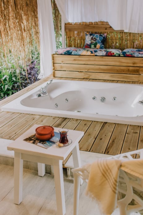 Outdoor bathroom with wooden floor and sunken Jacuzzi