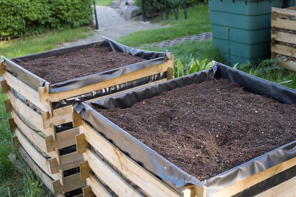 Two pallet-made compost bins filled with homemade mulch.