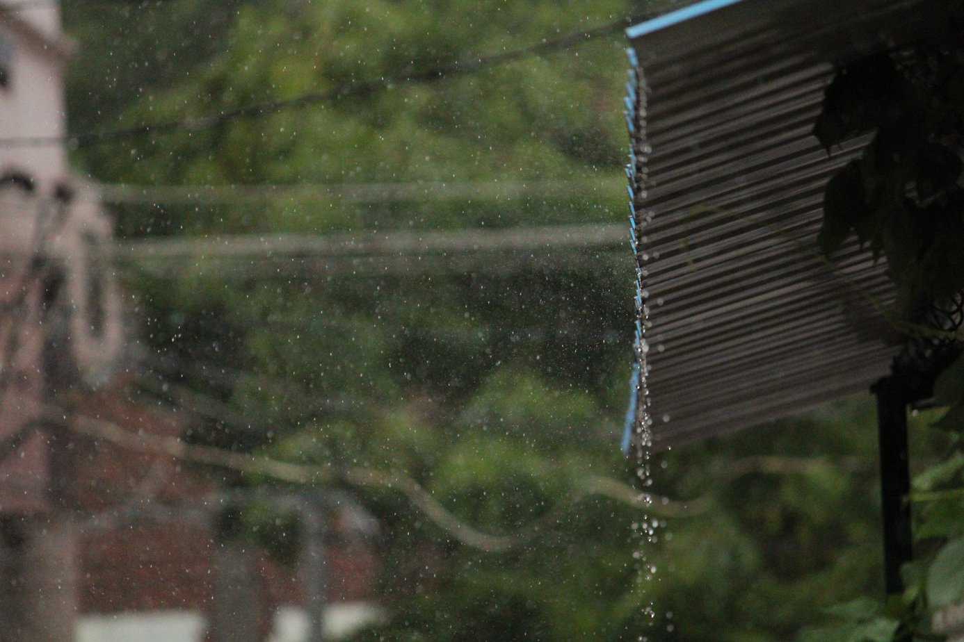 Rainwater falling from a shed.