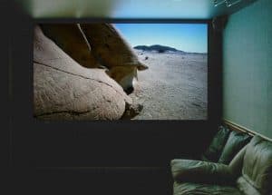 Home theatre projection screen displaying a high-definition television image