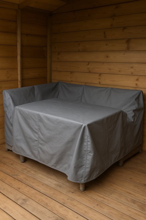 Rattan furniture set covered and stored inside a wooden shed