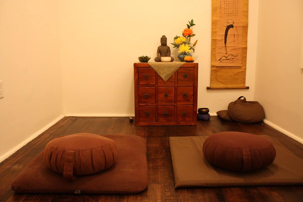 Meditation room set up with mats and pillows arrangements.