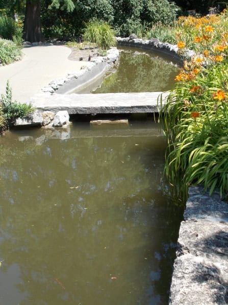 Stone bridge over a channel of a Japanese garden.