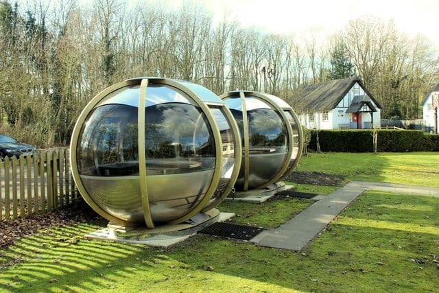 Two dining pods outside The Three Horseshoes pub in Madingley, set up for all-weather dining.