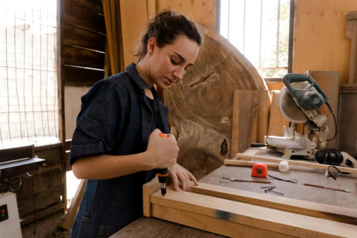 A woman doing woodwork.