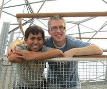 Mark and Gaz from Alternative Eden leaning over a railing and smiling