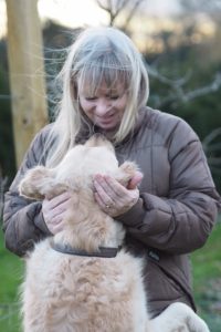 Julie from Peonies & Posies looking at and playing with her dog