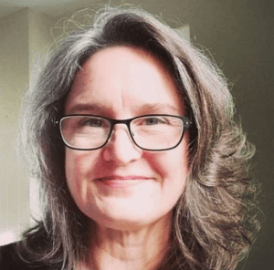 Sheila Averbuch of The Stopwatch Gardener wearing glasses and smiling