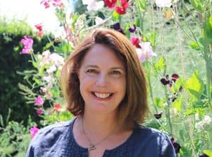 Katharine Woods stood in front of tall flowers