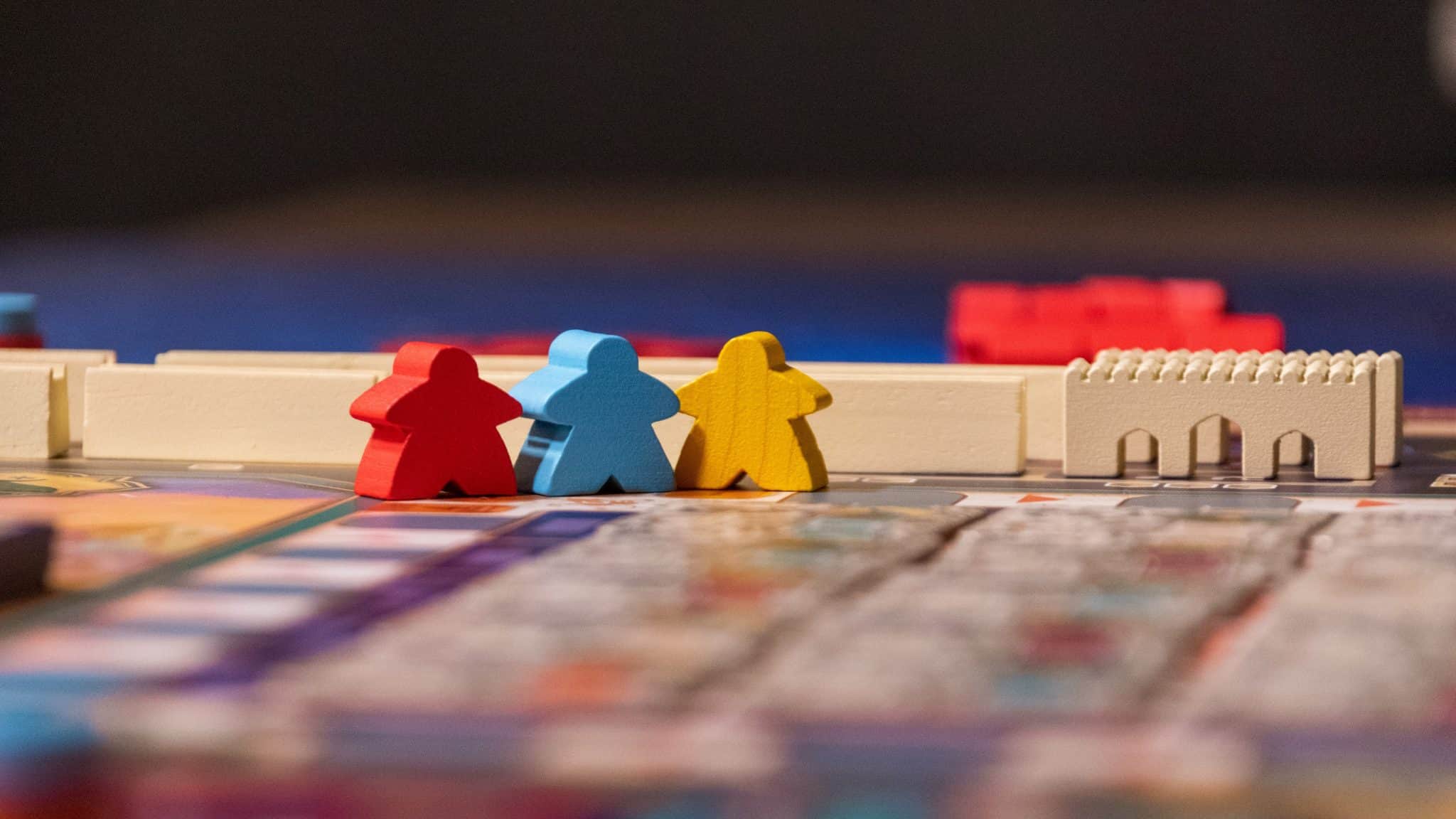 board game with multi-coloured wooden character pieces